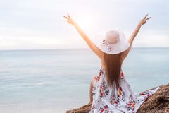 Beauty woman doing cheerful gesture beside the beach. Woman raise two hands and breathing fresh air happily. People and Lifestyle royalty free stock image Beauty woman doing cheerful gesture beside the beach. Woman raise two hands and breathing fresh air happily. People and Lifestyle royalty free stock image