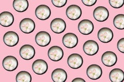 On a bed of coral background are many open jars of cream, in a jar is a flower stock images On a bed of coral background are many open jars of cream, in a jar is a flower stock images