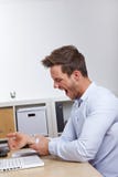 Bedrijfs mens in bureauholding van hem stock foto Bedrijfs mens in bureauholding van hem stock foto