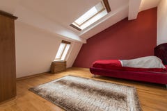 Bedroom interior in luxury red loft, attic, apartment with roof stock images Bedroom interior in luxury red loft, attic, apartment with roof stock images