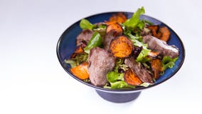 Beef salad with sweet potatoes in blue chinese bowl on white background royalty free stock image Beef salad with sweet potatoes in blue chinese bowl on white background royalty free stock image