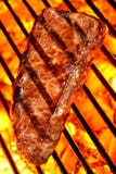 Beef steak on a fire hot barbecue grill