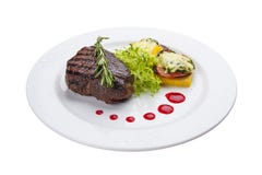 Beef steak with grilled vegetables and an omelette. On a white plate royalty free stock photo Beef steak with grilled vegetables and an omelette. On a white plate royalty free stock photo