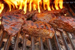 Beef Steak On The BBQ Grill With Flames. Royalty Free Stock Photos