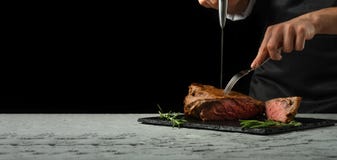 Beef Steak With Rosemary On A Black Background With Open Space For Text Or Restaurant Menus. Horizontal Photo Black Text Area.Bane Royalty Free Stock Image Beef Steak With Rosemary On A Black Background With Open Space For Text Or Restaurant Menus. Horizontal Photo Black Text Area.Bane Royalty Free Stock Image