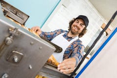 Beekeeper Standing At Honey Extraction Plant stock photography Beekeeper Standing At Honey Extraction Plant stock photography