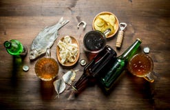 Beer with chips and squid rings in bowl and dried fish stock photography Beer with chips and squid rings in bowl and dried fish stock photography