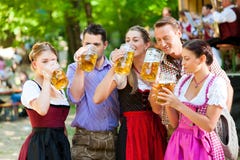 In Beer garden - friends in front of band royalty free stock images In Beer garden - friends in front of band royalty free stock images