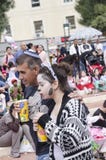 Beer-Sheva, ISRAEL - March 5, 2015: Father and daughter in costume drink juice in the crowd on the street - Purim royalty free stock photo Beer-Sheva, ISRAEL - March 5, 2015: Father and daughter in costume drink juice in the crowd on the street - Purim royalty free stock photo