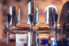 Beer tap at restaurant, bar or pub. Close-up details of beer draft taps in a row Royalty Free Stock Photography Beer tap at restaurant, bar or pub. Close-up details of beer draft taps in a row Royalty Free Stock Photography