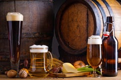 Beer and traditional food. Cellar still life with beer, traditional food and barrels Beer and traditional food. Cellar still life with beer, traditional food and barrels
