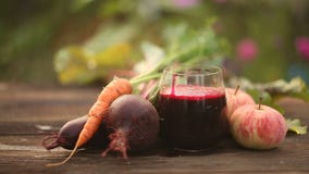 Beet-carrot-apple juice in glass on table