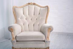 Beige Leather Wood Armchair With Golden Decor In A White Living Room Stock Photos