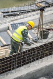 Old worker working on the retaining wall stock image Old worker working on the retaining wall stock image