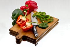 Bell Peppers Being Cutted At Wooden Cutting Board Royalty Free Stock Photo Bell Peppers Being Cutted At Wooden Cutting Board Royalty Free Stock Photo