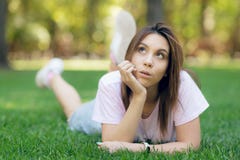 Bella donna sorridente che si trova su un'erba all'aperto fotografie stock libere da diritti Bella donna sorridente che si trova su un'erba all'aperto fotografie stock libere da diritti