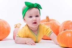 Bella neonata in un corpo giallo con l'arco verde sulla sua testa immagini stock Bella neonata in un corpo giallo con l'arco verde sulla sua testa immagini stock