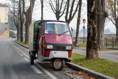 Traditional Italian three wheel car Piaggio Ape staying parked on the street Stock Photo Traditional Italian three wheel car Piaggio Ape staying parked on the street Stock Photo