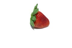A single fresh strawberry with leaves on white isolated background stock photography A single fresh strawberry with leaves on white isolated background stock photography