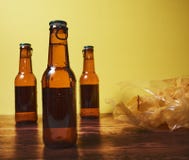 Bevanda e chip su una tavola di legno e su un fondo giallo fotografie stock libere da diritti Bevanda e chip su una tavola di legno e su un fondo giallo fotografie stock libere da diritti