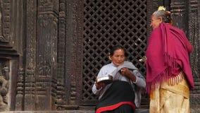 BHAKTAPUR, KATHMANDU, NEPAL - 18 October 2018 Newar people visiting hindu temple for worshiping in traditional clothes stock video footage BHAKTAPUR, KATHMANDU, NEPAL - 18 October 2018 Newar people visiting hindu temple for worshiping in traditional clothes stock video footage