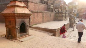 BHAKTAPUR, KATHMANDU, NEPAL - 18 October 2018 Daily traffic of pedestrians in oriental ancient city after earthquake stock footage BHAKTAPUR, KATHMANDU, NEPAL - 18 October 2018 Daily traffic of pedestrians in oriental ancient city after earthquake stock footage
