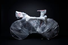 The bicycle is packed by bubble warp for transportation Royalty Free Stock Photos The bicycle is packed by bubble warp for transportation Royalty Free Stock Photos