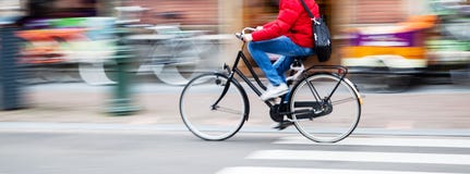 Bicycle Rider In The City In Motion Blur Stock Images