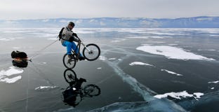 Bicycle tourist on the frozen lake royalty free stock image Bicycle tourist on the frozen lake royalty free stock image