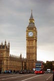 Big Ben Tower Near City Road With Bus and Cars Traveling Under Gray White Clouds Royalty Free Stock Images Big Ben Tower Near City Road With Bus and Cars Traveling Under Gray White Clouds Royalty Free Stock Images
