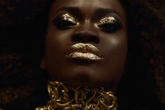 Big close-up surreal portrait of majestic african american female model with gold glossy makeup. Fashion Vogue concept royalty free stock images Big close-up surreal portrait of majestic african american female model with gold glossy makeup. Fashion Vogue concept royalty free stock images