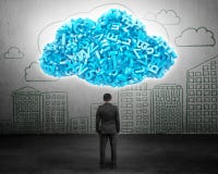Big data. Businessman facing blue characters in cloud shape royalty free stock photos Big data. Businessman facing blue characters in cloud shape royalty free stock photos