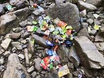 A big mass of rubbish lying all over the rocks and stones in a waterfall area. royalty free stock photos A big mass of rubbish lying all over the rocks and stones in a waterfall area. royalty free stock photos
