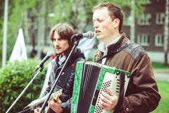 Singer at the microphone in the street stock photo Singer at the microphone in the street stock photo