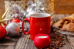 Big red cup of coffee, cookies filled with chocolate, Christmas balls, candles and coffee beans stock image Big red cup of coffee, cookies filled with chocolate, Christmas balls, candles and coffee beans stock image