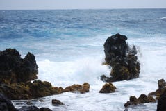 Big Rocks Surrounded by Body of Water Under Blue Sky at Daytime Stock Image Big Rocks Surrounded by Body of Water Under Blue Sky at Daytime Stock Image