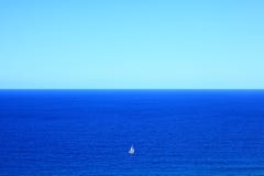 Big blue ocean small white boat vastness stock image Big blue ocean small white boat vastness stock image