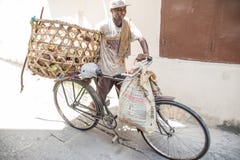 Biker! Local biker using his bike for transportation. Stone Town, Zanzibar. Tanzania royalty free stock photo Biker! Local biker using his bike for transportation. Stone Town, Zanzibar. Tanzania royalty free stock photo