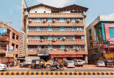Bikers and vehicles moving past colorful modern buildings on indian street Stock Photo Bikers and vehicles moving past colorful modern buildings on indian street Stock Photo
