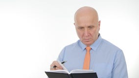 Binnenlands Beeld met Zakenman Writing in Agendapagina's stock afbeelding Binnenlands Beeld met Zakenman Writing in Agendapagina's stock afbeelding