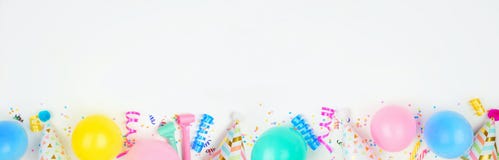 Birthday party banner with bottom border on a white background with balloons, party hats, streamers and confetti