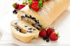 Biscuit Roll With Mascarpone Cream And Blueberries Decorated Strawberries, Blueberries And Mint Leaves Stock Photo