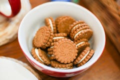 Biscuit cookie with white icing background on white and red plate on brown wooden table . tasty food for tea royalty free stock images Biscuit cookie with white icing background on white and red plate on brown wooden table . tasty food for tea royalty free stock images