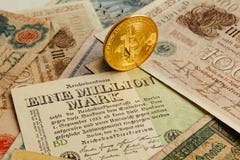 Bitcoin phisical coin with old german money. Cash Inflation. Cryptocurrency concept background. Closeup with copy space. royalty free stock images Bitcoin phisical coin with old german money. Cash Inflation. Cryptocurrency concept background. Closeup with copy space. royalty free stock images