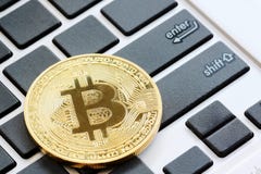 bitcoins placed on a black keyboard to see enter button in Crypt stock image bitcoins placed on a black keyboard to see enter button in Crypt stock image