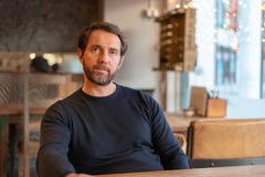 Bitter and disillusioned middle aged caucasian male sitting at the table in coffee shop royalty free stock images Bitter and disillusioned middle aged caucasian male sitting at the table in coffee shop royalty free stock images