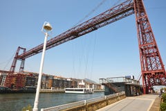 Bizkaia red iron hanging bridge and Nervion river. Euskadi