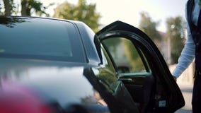 Biznesmen w kostiumu chodzi w kierunku wykonawczego samochodu, zwolnione tempo zdjęcie wideo Biznesmen w kostiumu chodzi w kierunku wykonawczego samochodu, zwolnione tempo zdjęcie wideo