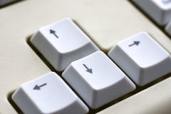 Black arrow on white buttons of a white keyboard close-up Stock Photography Black arrow on white buttons of a white keyboard close-up Stock Photography