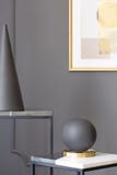 Black ball and cone on table against grey wall with poster in mu Royalty Free Stock Photo Black ball and cone on table against grey wall with poster in mu Royalty Free Stock Photo